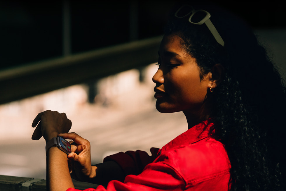 A user checks their Apple Watch Series 11 while running errands.